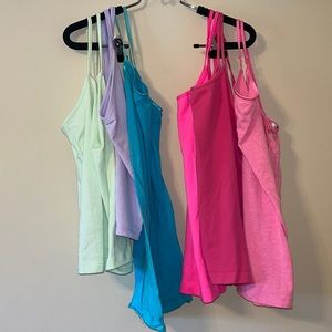 6 tank tops ranging from M-L green and purple are large the rest are Medium